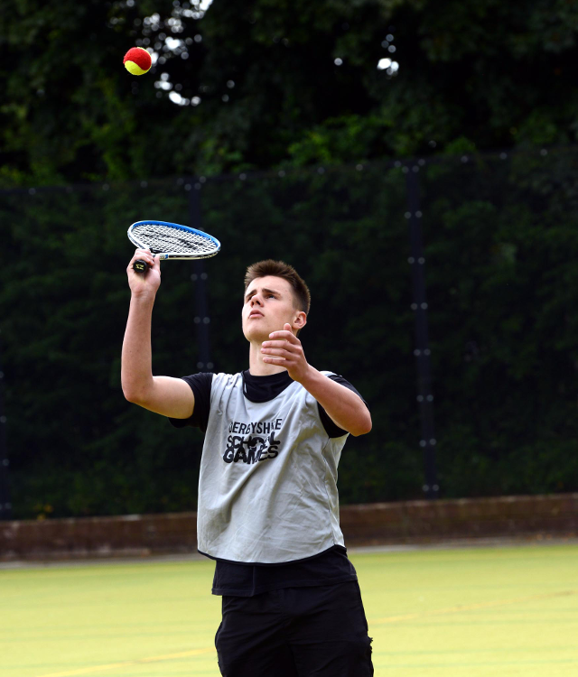 A Chesterfield Tennis player serving at Derbyshire School Games