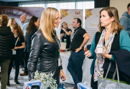 Two women speaking at a business expo