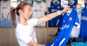 Female choosing a Chesterfield FC shirt in the club shop