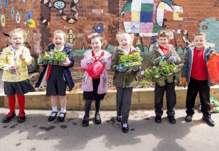 Learning in Chesterfield - Six pupils holding their plants in the garden at Heath Primary School