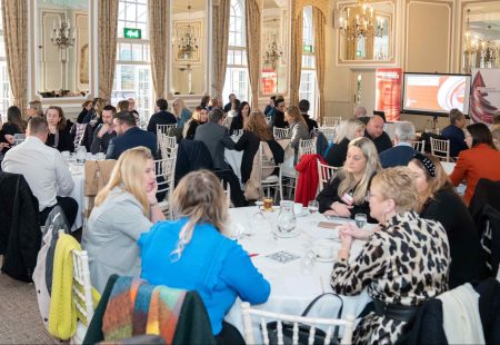 Large room of cabaret style tables with Chesterfield Champions attending event