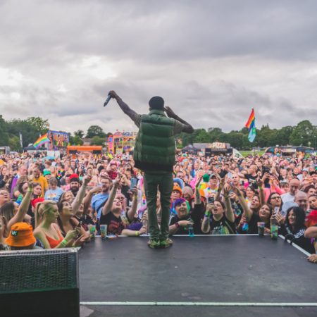 Man on a stage at Chesterfield Pride in front of a crowd