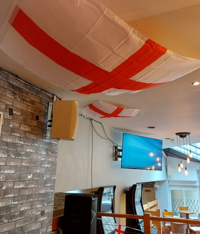 Interior of The Golden Fleece with England Flags on ceiling ahead of Euro 2024