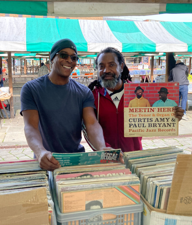 Stallholders at Chesterfield Record Fair holding up a vinyl record