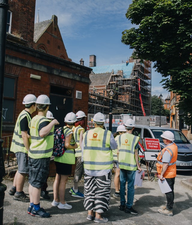 Students wearing high viz jackets outside Stephenson memorial hall