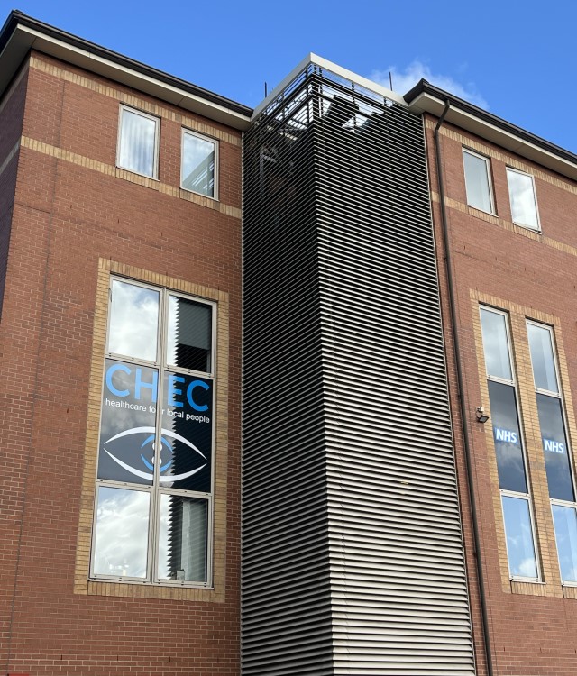 Exterior of modern office building with signs for eye care hospital in windows