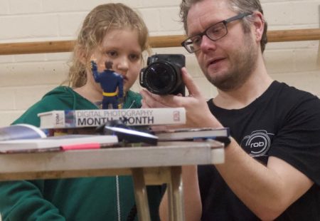 Instructor showing young person a camera