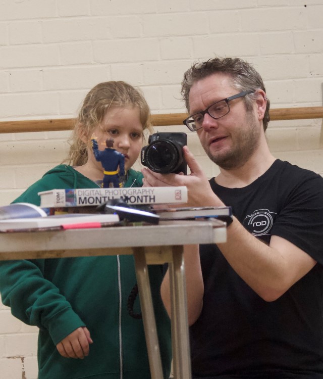 Instructor showing young person a camera