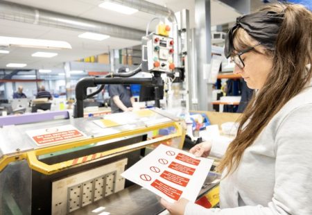 Professional female making labels in the warehouse at MTM Products in Chesterfield