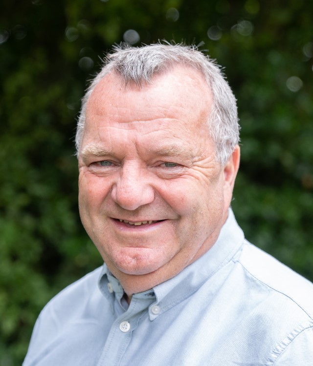 Peter Swallow smiling at camera