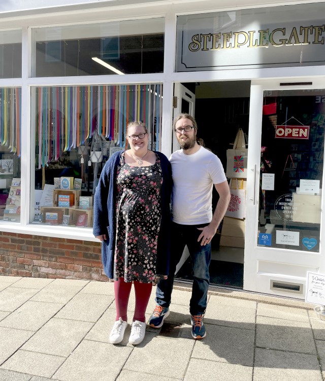 Shop owners stood together outside store