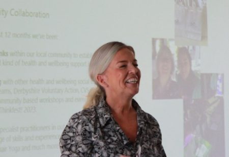 Woman presenting at event and smiling