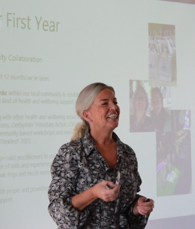 Woman presenting at event and smiling