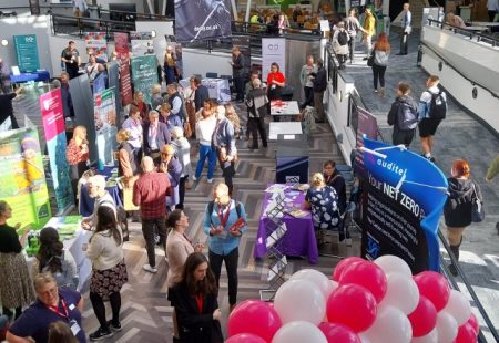 Busy University atrium with exhibitors displaying sustainability initiatives