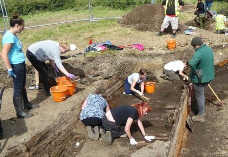 Team of volunteers digging in the mud at Chesterfield Canal