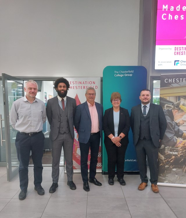 Business Leaders launching campaign at Chesterfield College wearing formal attire and smiling for the camera