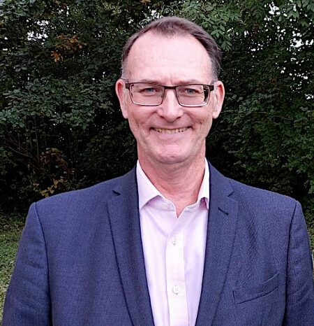 Man wearing smart clothing smiling at camera