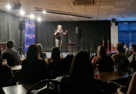 Stand up comedy taking place in front of an audience