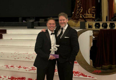 Staff members of Veezu holding an award