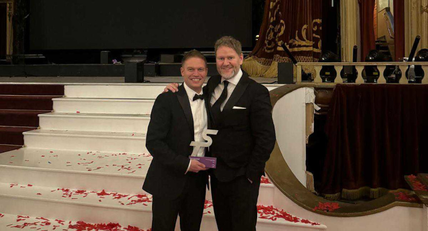 Staff members of Veezu holding an award