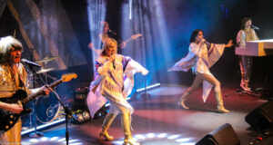 ABBA tribute band on stage performing.