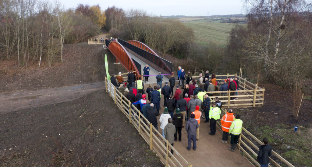 Cllr Renwick speaking, picture taken from the air showcasing whole bridge over canal