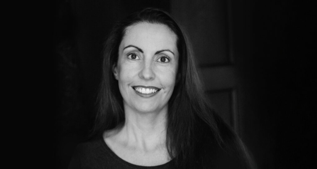 Black and white image of female business owner smiling at camera