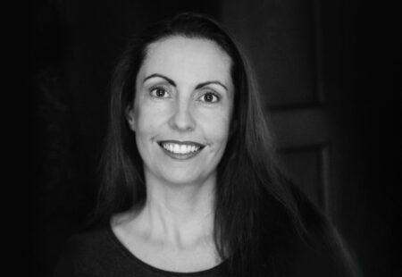 Black and white image of female business owner smiling at camera