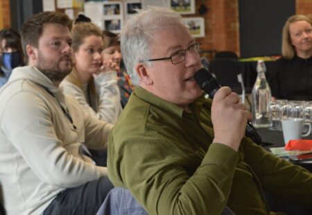 Audience member speaks into microphone at Derbyshire Creative Heritage Conferenc